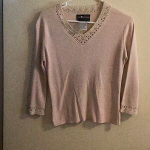 Vneck sweater with crochet neckline and cuffs.